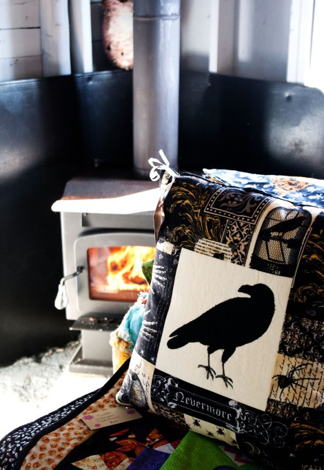 You can't get much cozier than a pillow and a wood stove.
